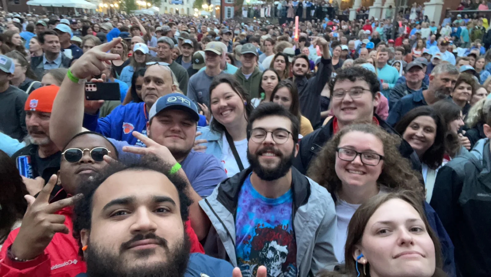 Friends pose in the crowd packed onto the Square in Oxford for an evening concert during Double Decker weekend.