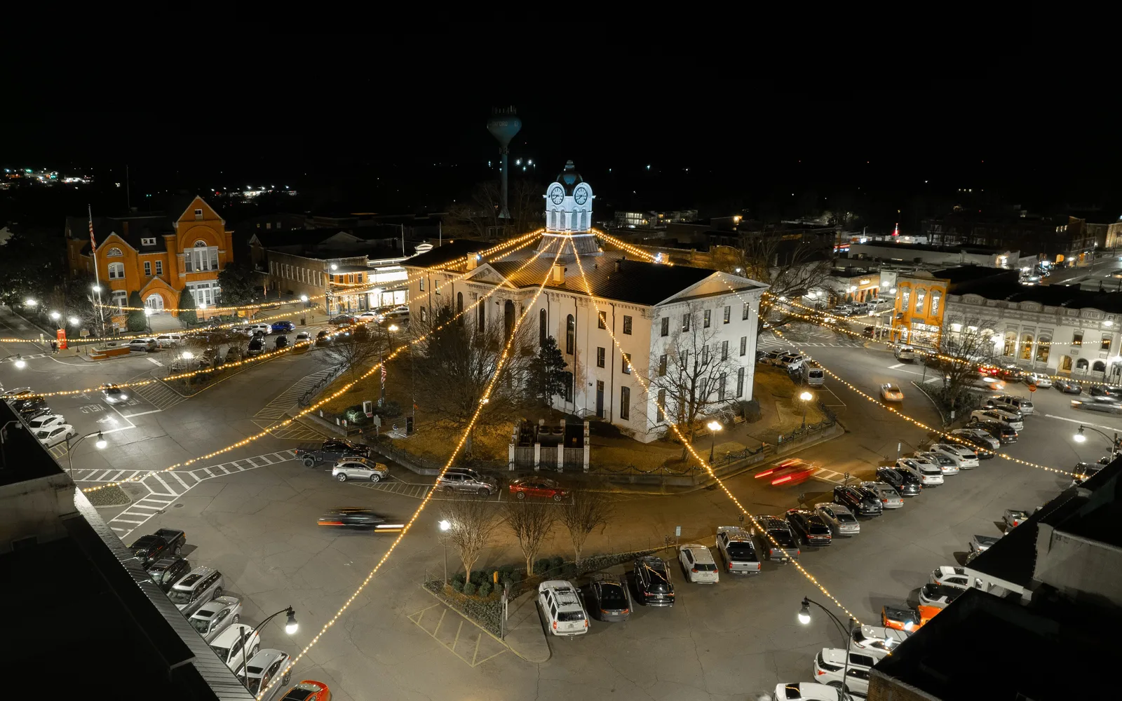 Strings of holiday lights run from the Lafayette County Courthouse across the Square in Oxford at night.