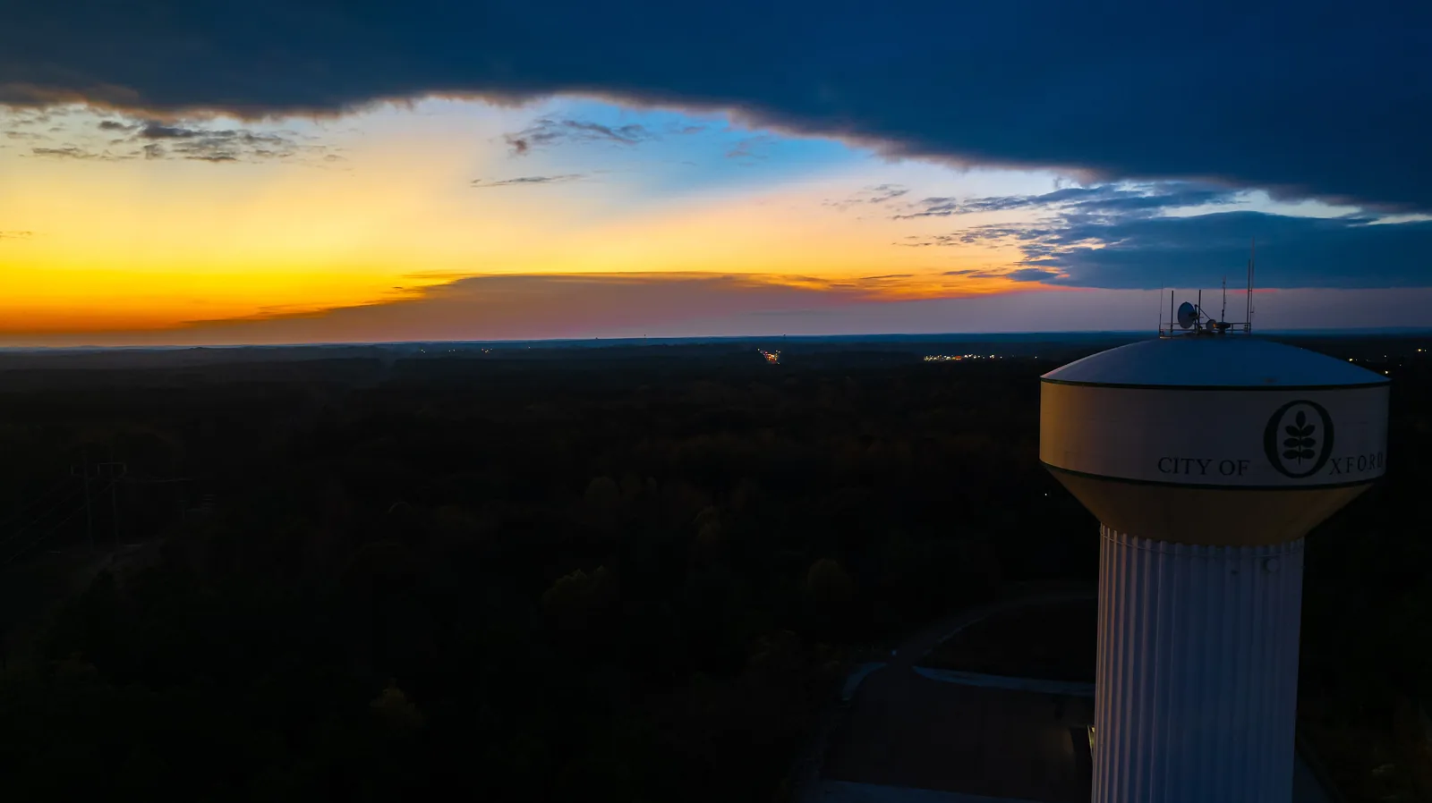 A City of Oxford water tower at sunset, with the view west toward Batesville.