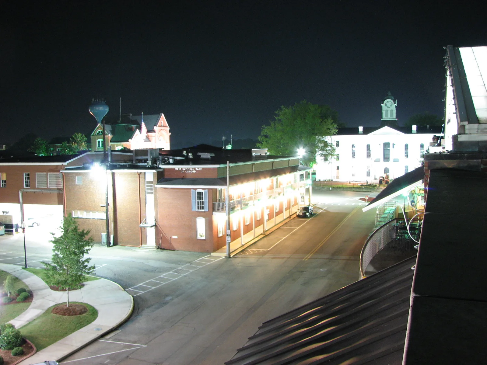 The north side of the Square in Oxford at night, with the Lafayette County Courthouse lit up at right.