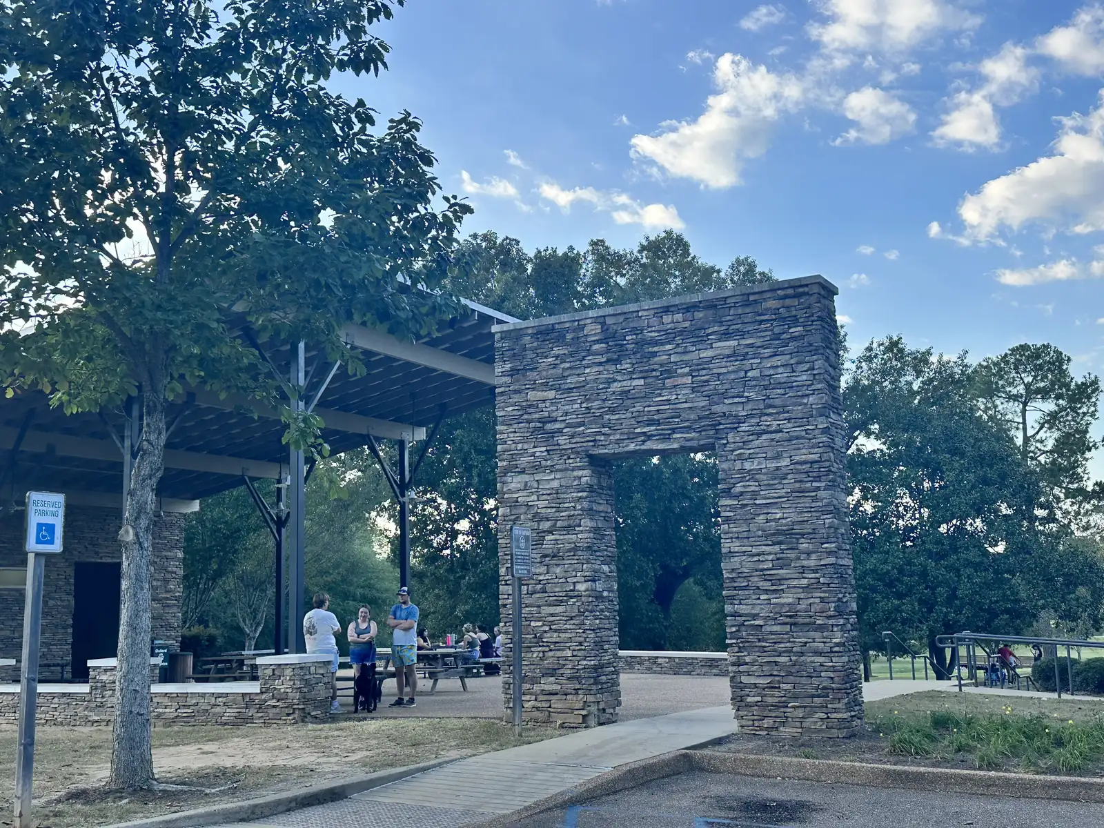 Visitors gather at the stone pavilion at Lamar Park in Oxford.