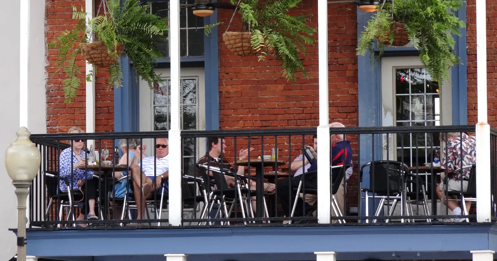 Diners eat on a second-floor balcony overlooking the Square in Oxford.
