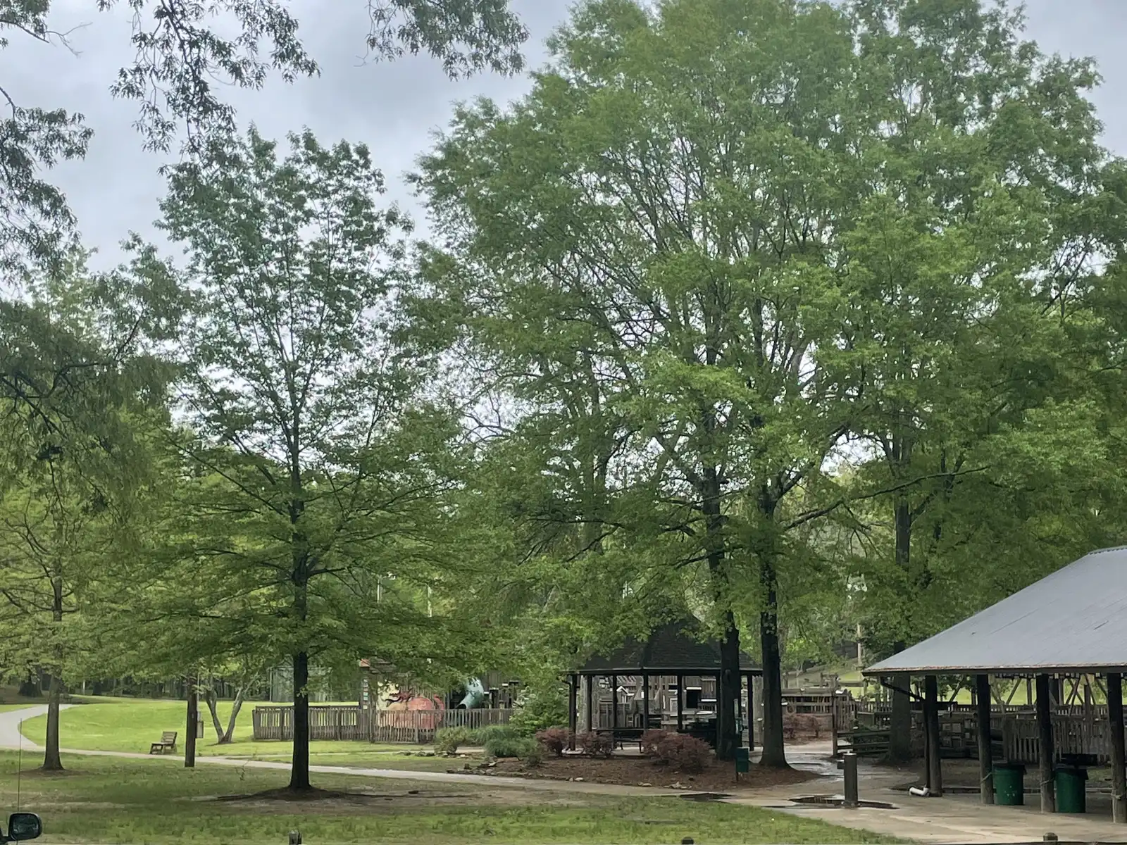 Shade trees, a picnic pavilion and the playground at Avent Park in Oxford in spring.